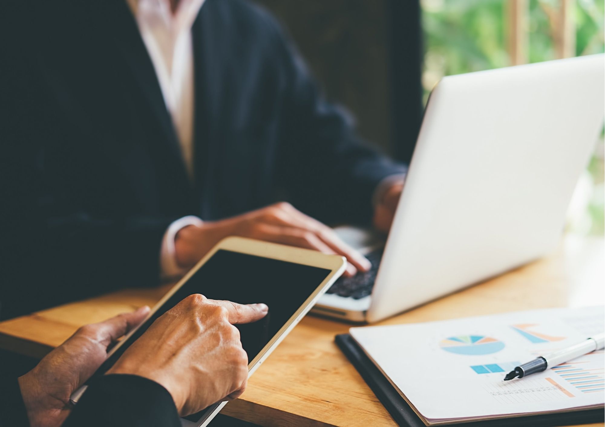 People using an ipad and a laptop