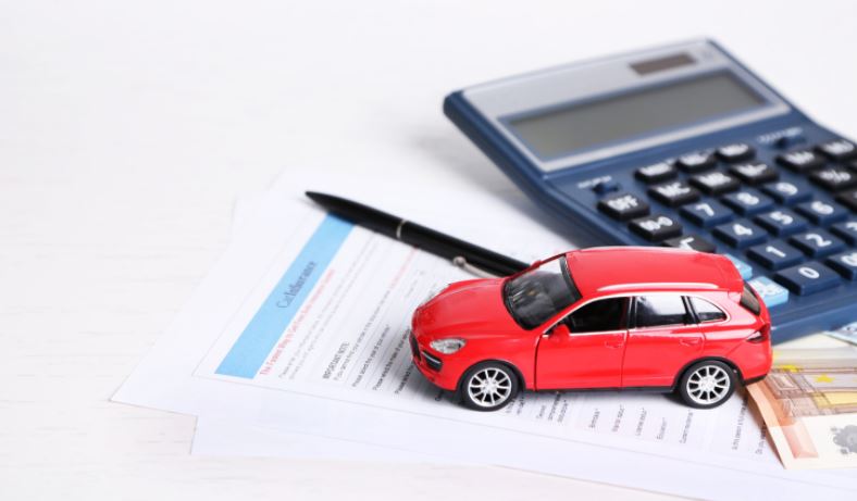 Toy car and calculator on some documents