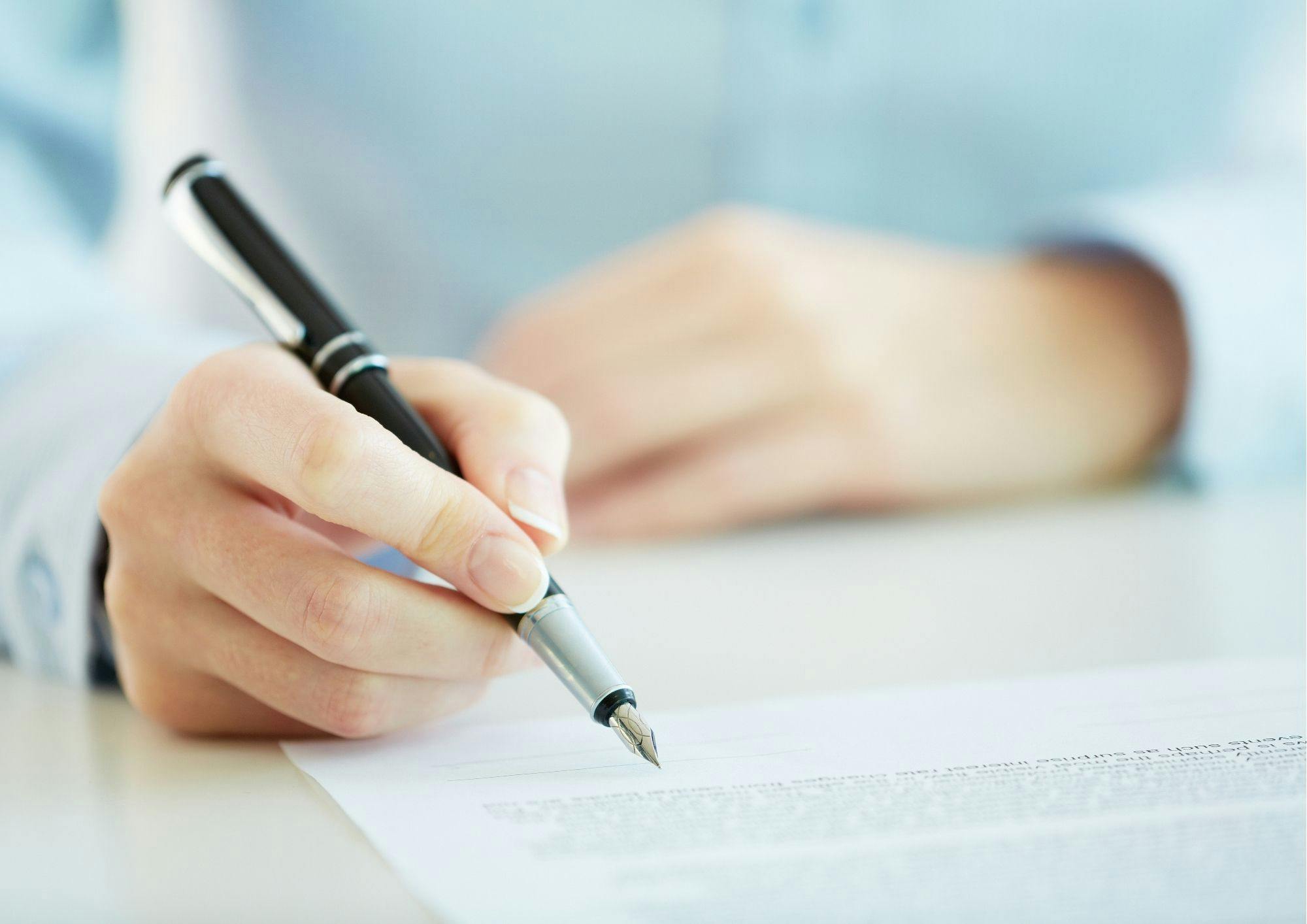 Person Writing on a document